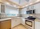 Updated kitchen with white cabinets, granite counters & stainless steel appliances at 5300 S Atlantic Ave # 9201, New Smyrna Beach, FL 32169