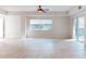 Bright living room with tile floors and sliding glass doors to balcony at 5300 S Atlantic Ave # 9201, New Smyrna Beach, FL 32169