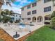 Backyard oasis featuring a kidney-shaped pool, slide, patio furniture, and lush landscaping at 610 S Atlantic Ave, New Smyrna Beach, FL 32169