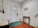 Bright entryway with terracotta floor, bench, and small table at 610 S Atlantic Ave, New Smyrna Beach, FL 32169
