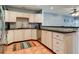 Bright kitchen with light wood cabinets, granite countertops, and colorful rug at 610 S Atlantic Ave, New Smyrna Beach, FL 32169