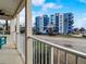 View from a condo balcony overlooking a street and a multi-story building at 610 S Atlantic Ave, New Smyrna Beach, FL 32169