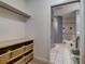 Bathroom closet with shelves and wicker baskets at 610 S Atlantic Ave, New Smyrna Beach, FL 32169