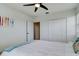 Bedroom with queen bed, ceiling fan, and access to hallway at 610 S Atlantic Ave, New Smyrna Beach, FL 32169