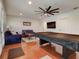 Game room with pool table, sofas, and a large TV at 610 S Atlantic Ave, New Smyrna Beach, FL 32169
