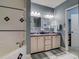 Bathroom with double vanity and soaking tub at 610 S Atlantic Ave, New Smyrna Beach, FL 32169