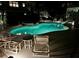 Lighted pool and spa with waterslide at night at 610 S Atlantic Ave, New Smyrna Beach, FL 32169