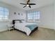 Bright bedroom with a queen bed, ceiling fan, and large windows at 610 S Atlantic Ave, New Smyrna Beach, FL 32169