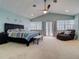 Spacious main bedroom with king-size bed, sitting area, and access to balcony at 610 S Atlantic Ave, New Smyrna Beach, FL 32169