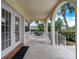 Covered balcony with white chairs and small table at 610 S Atlantic Ave, New Smyrna Beach, FL 32169
