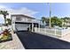 Two story home with white exterior, large deck, and garage at 830 Maralyn Ave, New Smyrna Beach, FL 32169