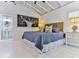 Main bedroom with ensuite bathroom and whitewashed wood floors at 830 Maralyn Ave, New Smyrna Beach, FL 32169
