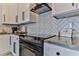 Modern kitchen with stainless steel appliances and herringbone backsplash at 830 Maralyn Ave, New Smyrna Beach, FL 32169