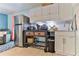 Small galley kitchen with stainless steel appliances and white cabinets at 830 Maralyn Ave, New Smyrna Beach, FL 32169