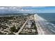 Aerial view of beach town, showcasing houses, ocean, and shoreline at 830 Maralyn Ave, New Smyrna Beach, FL 32169