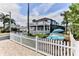 Two-story home with a white exterior and a putting green at 830 Maralyn Ave, New Smyrna Beach, FL 32169