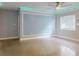 Living room with light grey shiplap accent wall and concrete flooring at 104 Fran Dr, New Smyrna Beach, FL 32168