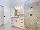 Bright bathroom with granite vanity and shower at 804 Soft Pine Ct, New Smyrna Beach, FL 32168