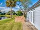 Private back patio with lake view and brick wall at 804 Soft Pine Ct, New Smyrna Beach, FL 32168