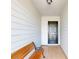Inviting entryway with a wooden bench and tiled floor at 804 Soft Pine Ct, New Smyrna Beach, FL 32168