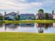 Scenic view of lakefront homes with lush greenery at 804 Soft Pine Ct, New Smyrna Beach, FL 32168