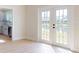 Light-filled dining area with hardwood floors and French doors to patio at 804 Soft Pine Ct, New Smyrna Beach, FL 32168