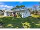 Side yard view of a single-Gathering home with landscaping at 1213 Jeffery Dr, Port Orange, FL 32129