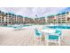 Community pool and patio furniture, ideal for relaxation at 4501 S Atlantic Ave # 1210, New Smyrna Beach, FL 32169