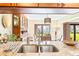 Kitchen with granite countertops, stainless steel sink, and view to dining area at 4501 S Atlantic Ave # 1210, New Smyrna Beach, FL 32169