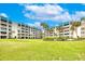 Expansive grassy lawn with mature trees and landscaping at 4501 S Atlantic Ave # 1210, New Smyrna Beach, FL 32169