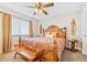 King bedroom with wood furniture and tropical bedding at 4501 S Atlantic Ave # 1210, New Smyrna Beach, FL 32169