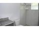 Clean bathroom with shower, granite countertop, and updated fixtures at 181 N Putnam Grove Rd, Oak Hill, FL 32759