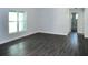 Bright living room with hardwood floors and access to other rooms at 181 N Putnam Grove Rd, Oak Hill, FL 32759