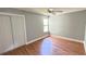 Bright bedroom with hardwood floors and ceiling fan at 806 Pine Shores Cir, New Smyrna Beach, FL 32168