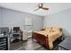 Bedroom with a double bed, workspace, and window at 1795 Hideaway Ln, Edgewater, FL 32141