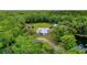 House nestled in a private wooded area near a pond at 1795 Hideaway Ln, Edgewater, FL 32141