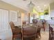 Bright dining area with wicker chairs and glass table, adjacent to kitchen at 2700 N Peninsula Ave # 536, New Smyrna Beach, FL 32169