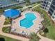 Community pool with surrounding patio at 2700 N Peninsula Ave # 536, New Smyrna Beach, FL 32169
