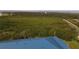 Aerial view showcasing the home's blue metal roof and surrounding landscape at 2700 N Peninsula Ave # 536, New Smyrna Beach, FL 32169