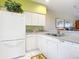 White kitchen with stainless steel appliances and breakfast bar at 2700 N Peninsula Ave # 536, New Smyrna Beach, FL 32169