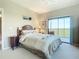 Bedroom with balcony access and view of lush greenery at 2700 N Peninsula Ave # 536, New Smyrna Beach, FL 32169