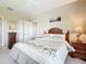 Bright bedroom with palm tree bedding and wood furniture at 2700 N Peninsula Ave # 536, New Smyrna Beach, FL 32169