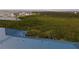 Aerial view showing home's blue metal roof, waterfront lot, and lush vegetation at 2700 N Peninsula Ave # 536, New Smyrna Beach, FL 32169