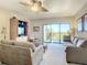 Living room features a large window, comfortable seating and a ceiling fan at 2700 N Peninsula Ave # 536, New Smyrna Beach, FL 32169