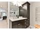 Elegant bathroom with dark vanity and a large mirror at 3001 S Atlantic Ave # 502, New Smyrna Beach, FL 32169