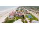 Aerial view of condo complex near beach and tennis court at 3001 S Atlantic Ave # 502, New Smyrna Beach, FL 32169
