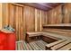 Relaxing wood sauna with benches and red bucket at 3001 S Atlantic Ave # 502, New Smyrna Beach, FL 32169