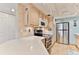 Modern kitchen with stainless steel appliances and light wood cabinets at 3001 S Atlantic Ave # 502, New Smyrna Beach, FL 32169