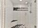 Large walk-in shower with black and white hexagonal tile at 3001 S Atlantic Ave # 502, New Smyrna Beach, FL 32169
