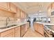 Bright kitchen features stainless steel appliances and light wood cabinets at 3001 S Atlantic Ave # 502, New Smyrna Beach, FL 32169